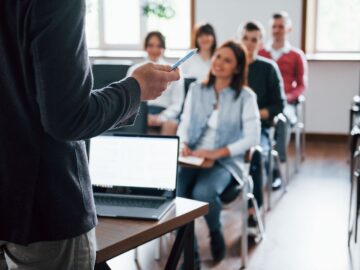 Group of people at a lecture in modern classroom at daytime