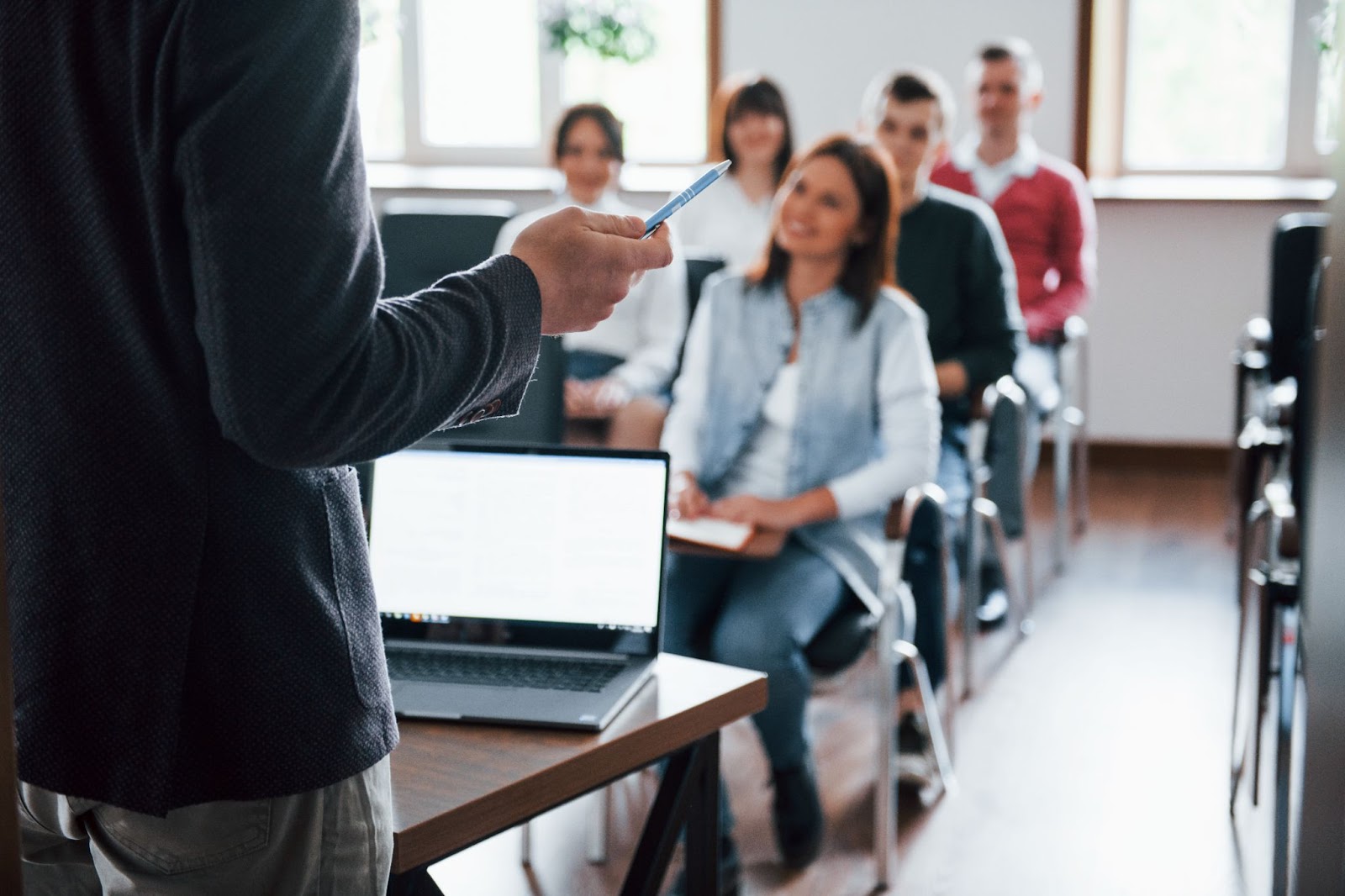 Group of people at a lecture in modern classroom at daytime